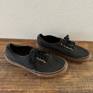 Black and gold Vans